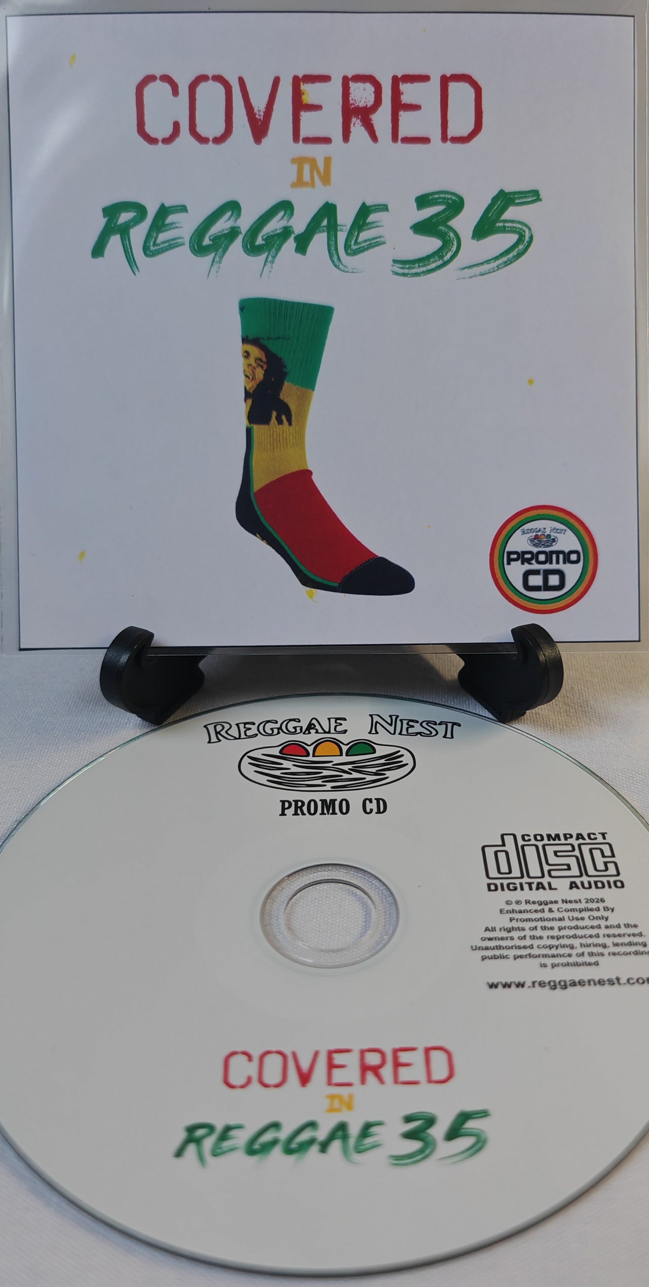 Promo CD for 'Covered in Reggae 35' with a colorful sock design on a white background.
