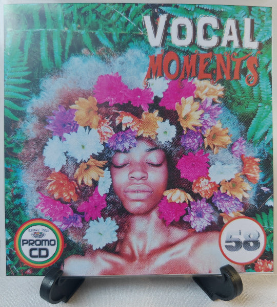 CD cover with a person with flowers in their hair against a tropical leaf background, labeled 'Vocal Moments'.