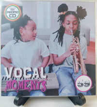 Thumbnail for Promo CD cover with two children, one playing a trumpet and the other sitting next to a keyboard, titled 'Vocal Moments'.